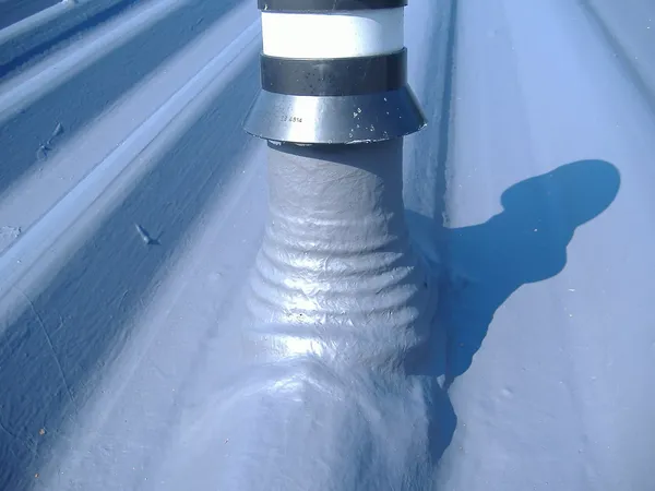 Close-up of liquid applied waterproofing membrane showing seamless finish on commercial flat roof