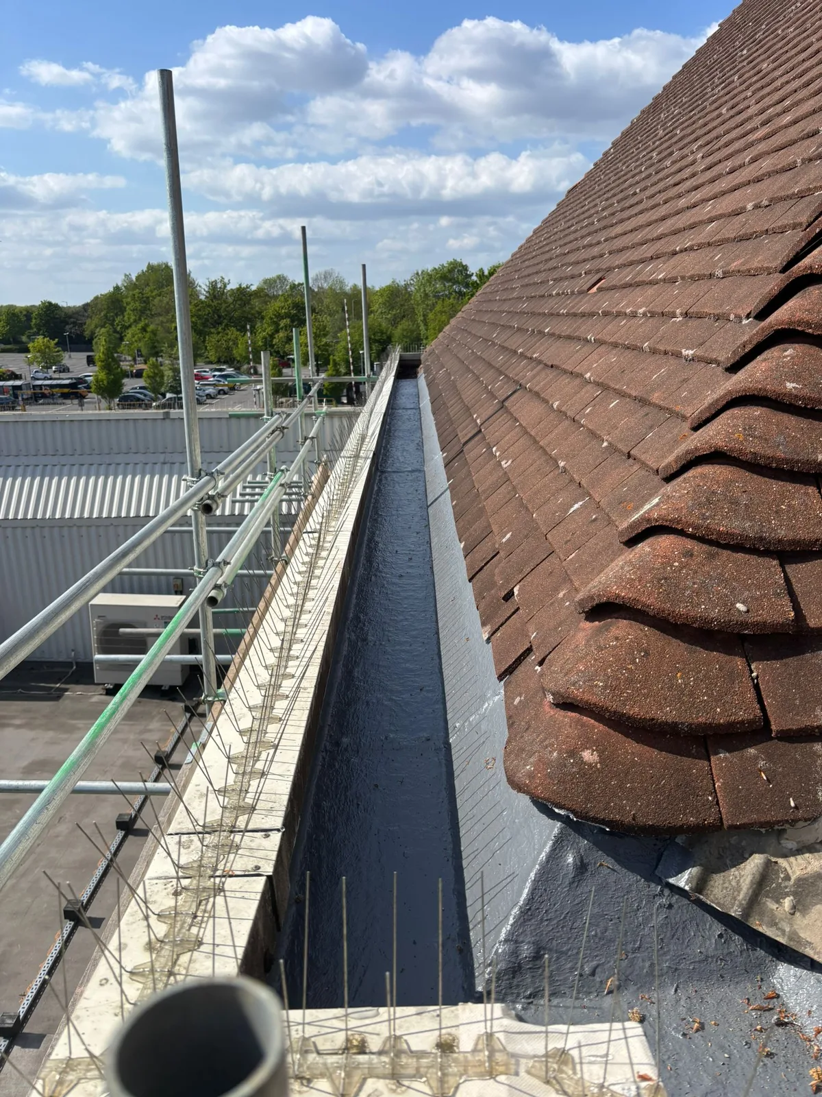 Gutter lining at the junction with the corner of the pitched roof