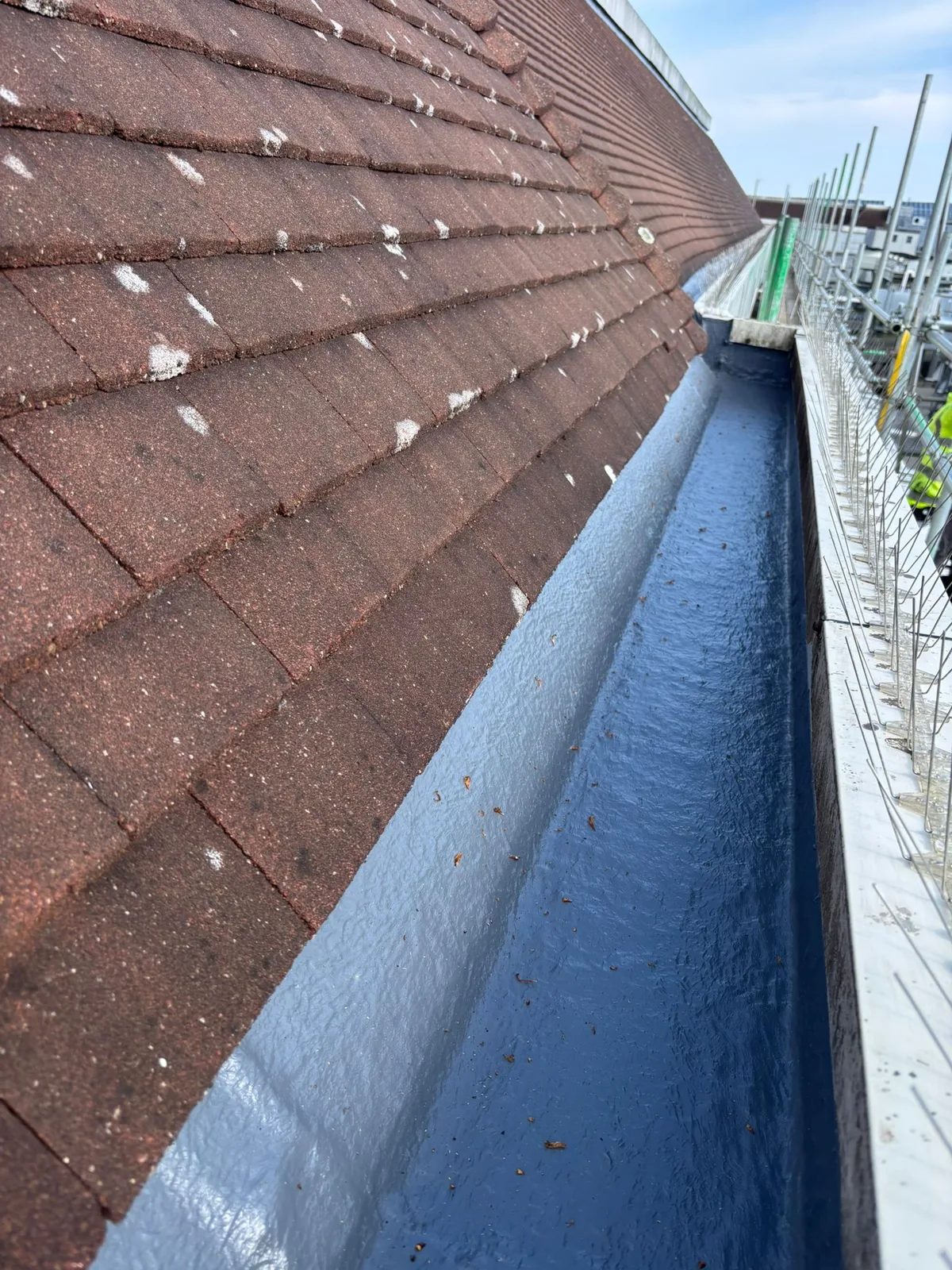 Close view of liquid lining on the gutter base and sides