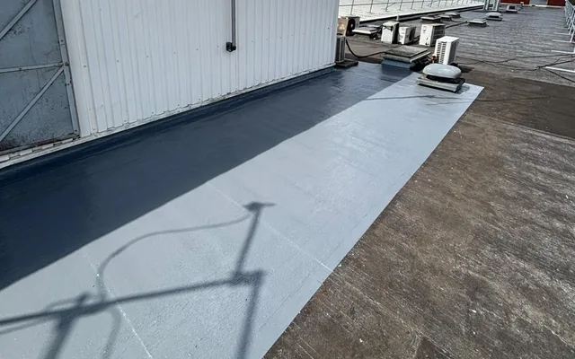 Liquid waterproofing patch beside a rooftop plant enclosure in Hemel Hempstead